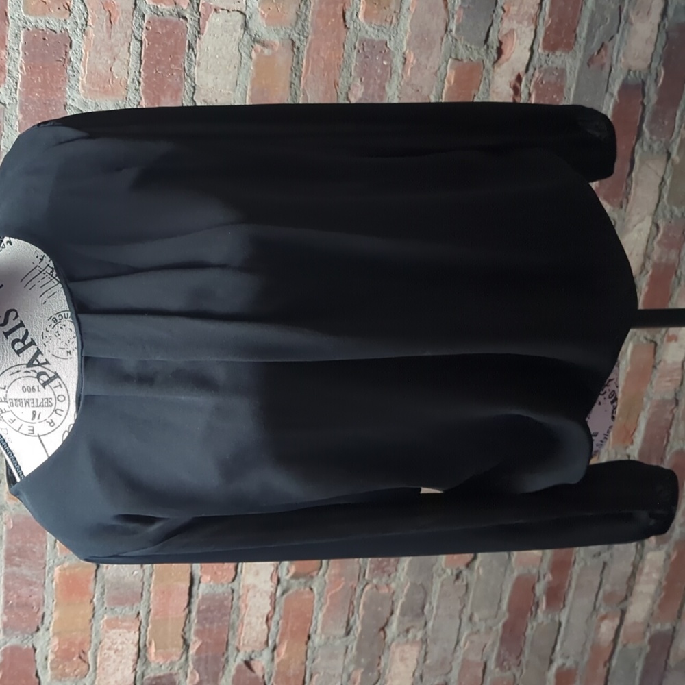Black blouse with lace insert in back.